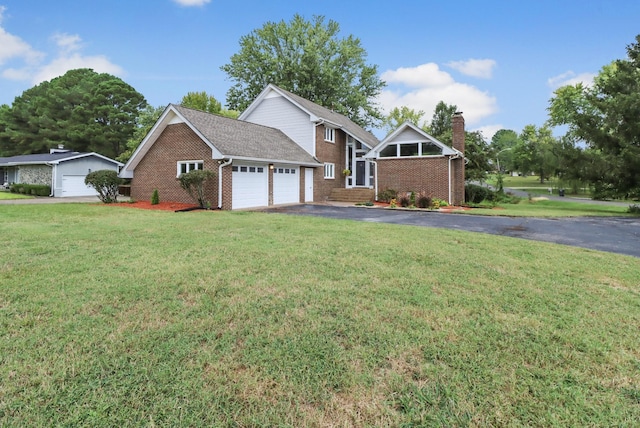 view of front of home with a garage and a front lawn