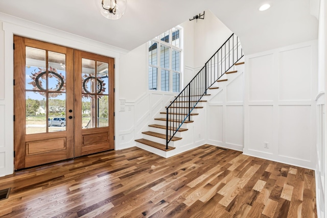 foyer entrance with dark hardwood / wood-style flooring and french doors