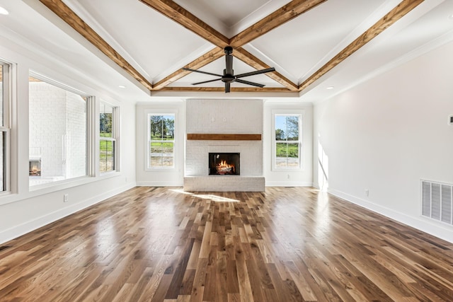 unfurnished living room with coffered ceiling, wood-type flooring, a fireplace, and crown molding