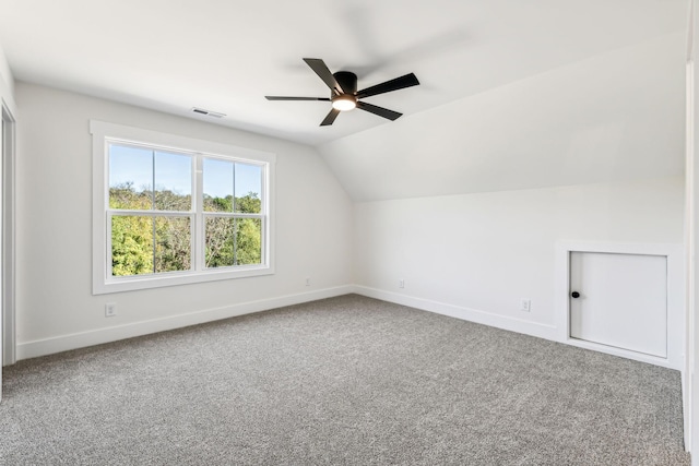 additional living space featuring ceiling fan, lofted ceiling, and carpet