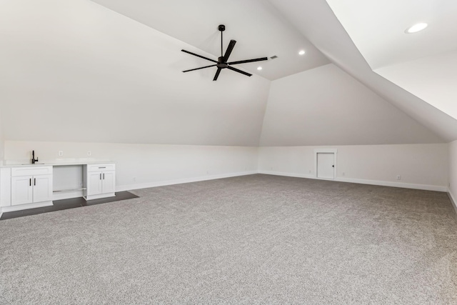 bonus room featuring sink, carpet floors, ceiling fan, and vaulted ceiling