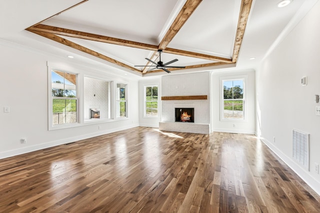 unfurnished living room featuring ceiling fan, plenty of natural light, and a fireplace