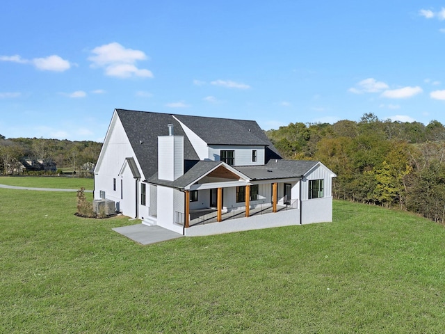 rear view of house with a yard and a patio