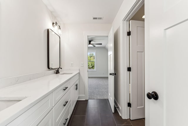 bathroom with ceiling fan, tile patterned floors, and vanity