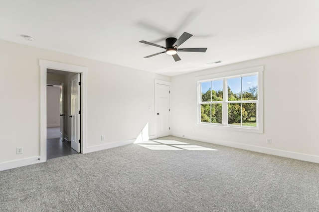 carpeted spare room featuring ceiling fan