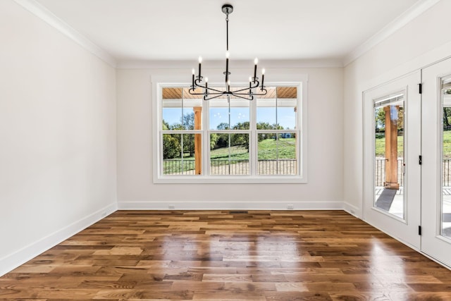 unfurnished dining area with crown molding, a chandelier, and dark hardwood / wood-style floors