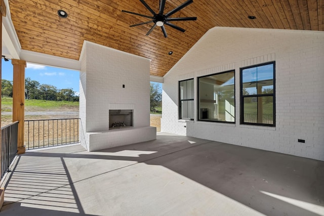 view of patio / terrace with an outdoor brick fireplace and ceiling fan