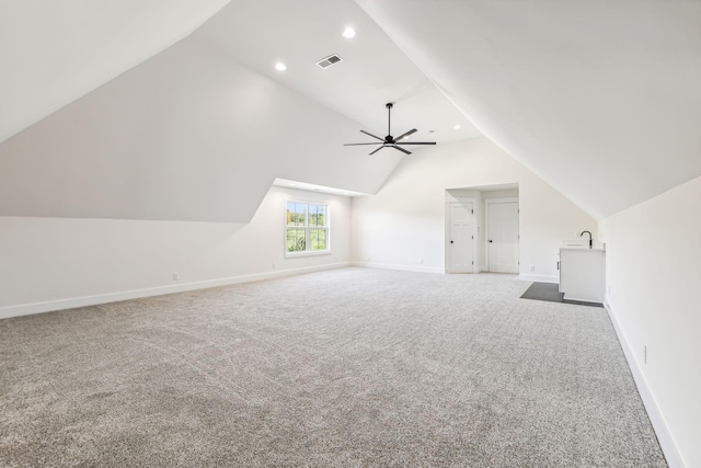 additional living space with lofted ceiling, ceiling fan, and carpet