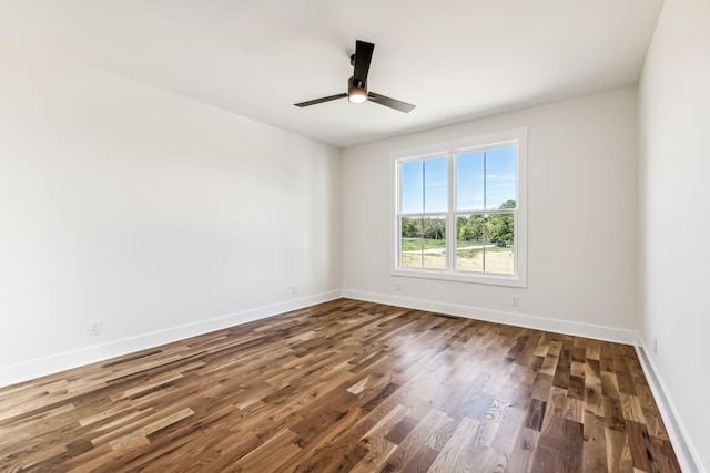 spare room with hardwood / wood-style flooring and ceiling fan