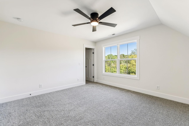 interior space featuring ceiling fan, vaulted ceiling, and carpet