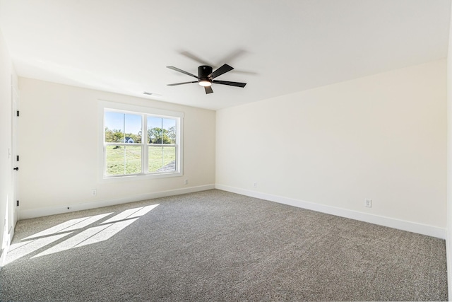 empty room featuring ceiling fan and carpet