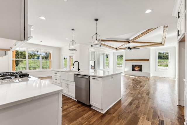 kitchen featuring stainless steel dishwasher, a kitchen island with sink, white cabinets, coffered ceiling, and sink