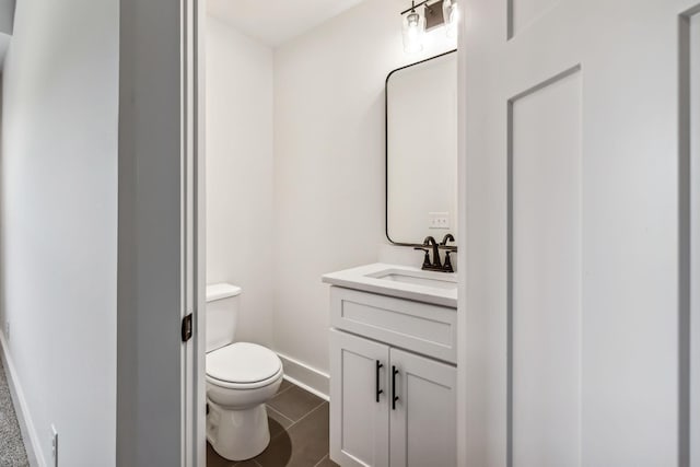 bathroom featuring toilet, tile patterned floors, and vanity