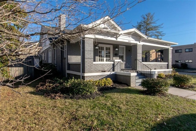 bungalow-style house with a porch and a front lawn