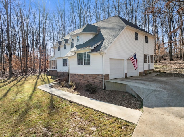 view of side of property featuring a yard and a garage