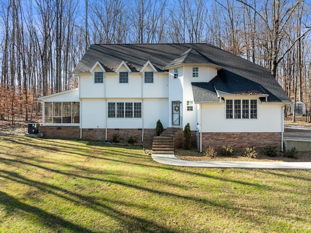 view of front of home with a front yard and a sunroom