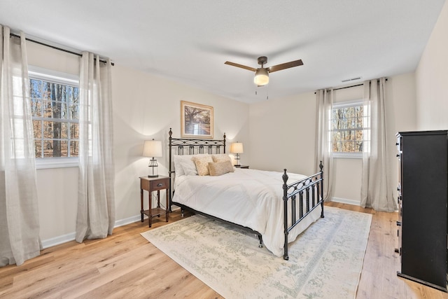 bedroom with ceiling fan and light hardwood / wood-style flooring