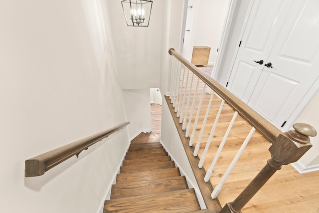 stairway featuring a chandelier and hardwood / wood-style flooring