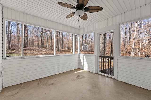 unfurnished sunroom with ceiling fan