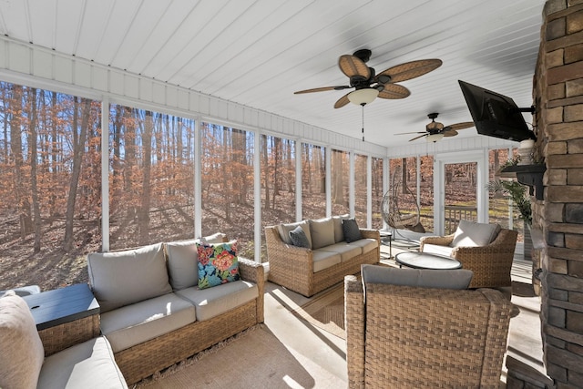 sunroom / solarium featuring ceiling fan