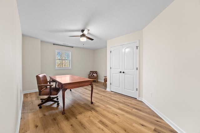 office with ceiling fan and light hardwood / wood-style floors