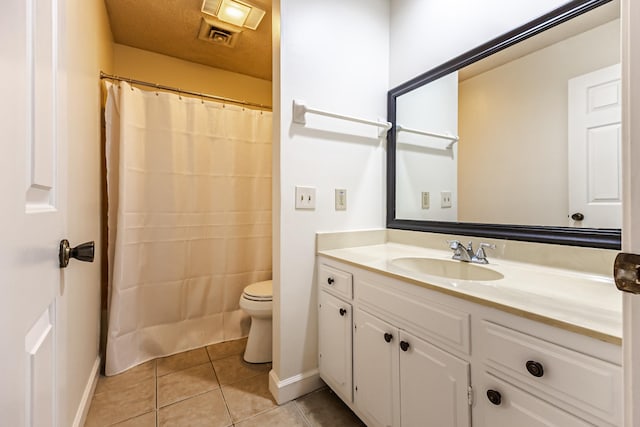 bathroom featuring toilet, vanity, and tile patterned floors