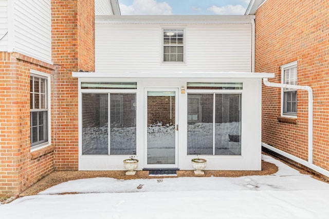 view of snow covered property entrance