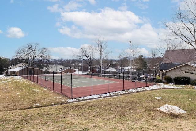 view of tennis court with a yard