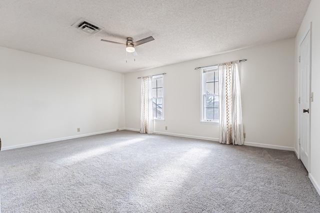 unfurnished room with a textured ceiling, ceiling fan, and carpet flooring