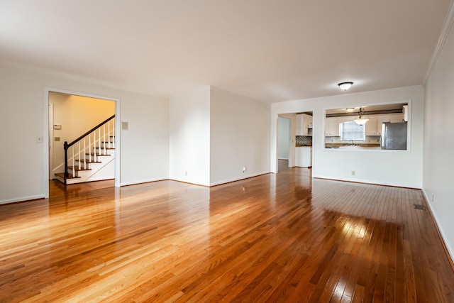 unfurnished living room with hardwood / wood-style flooring