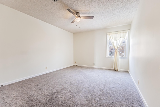 carpeted spare room featuring a textured ceiling and ceiling fan