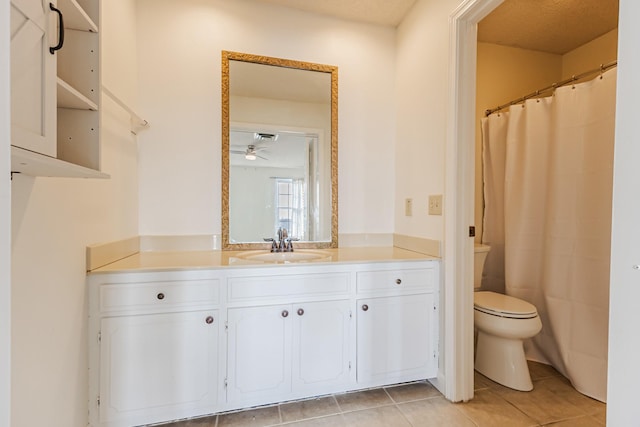 bathroom featuring toilet, vanity, tile patterned floors, and ceiling fan