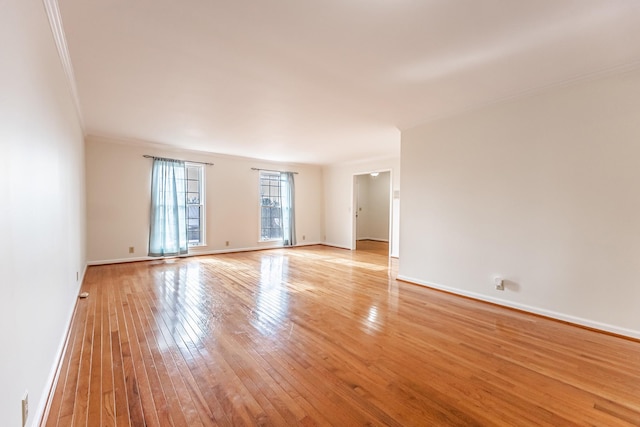 empty room featuring light hardwood / wood-style floors and crown molding