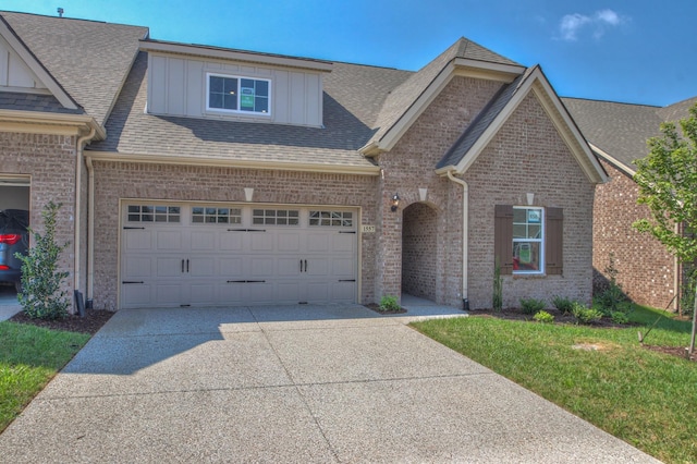 view of front facade with a front yard and a garage