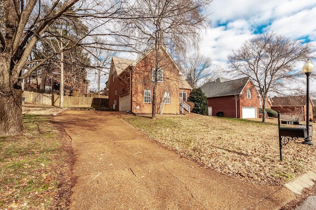 view of front of property featuring a front yard and a garage