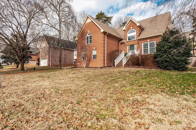 rear view of house featuring a lawn