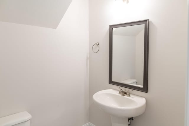 bathroom with toilet and a sink