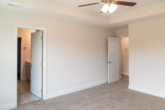 unfurnished bedroom with light carpet, visible vents, and baseboards