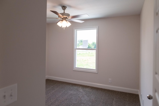 carpeted empty room featuring a ceiling fan and baseboards