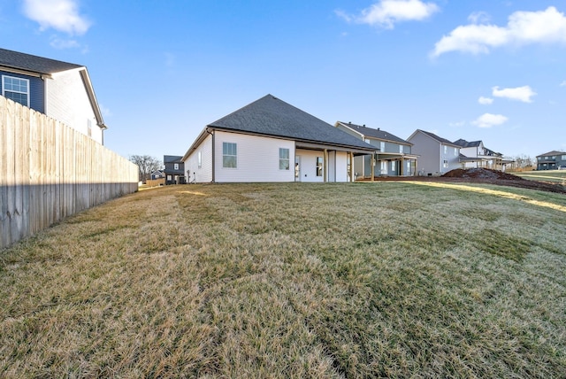 back of house with a lawn