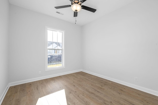 empty room featuring ceiling fan and light hardwood / wood-style flooring