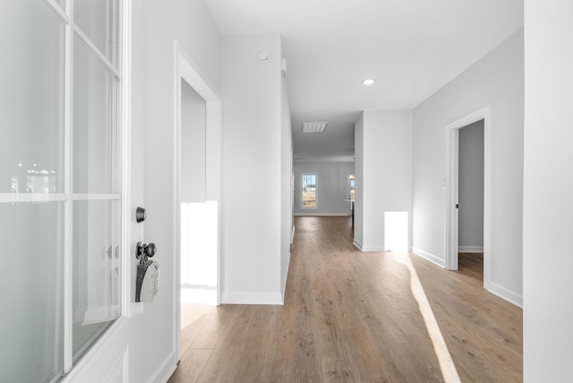 hall with light hardwood / wood-style floors