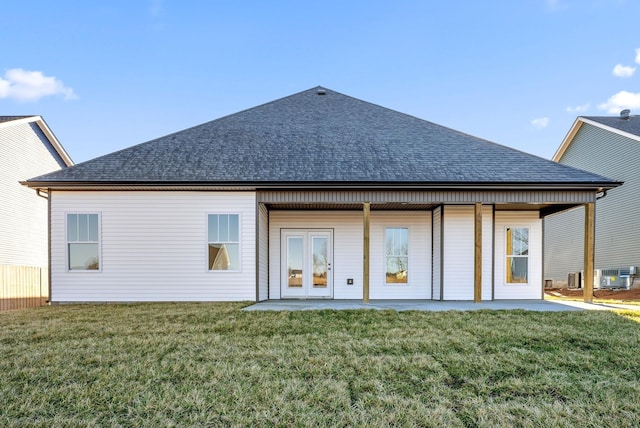 rear view of house with french doors, a patio, central air condition unit, and a lawn