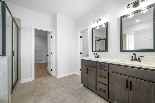 bathroom featuring walk in shower and vanity