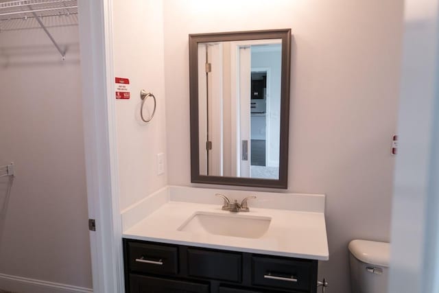 bathroom featuring toilet and vanity