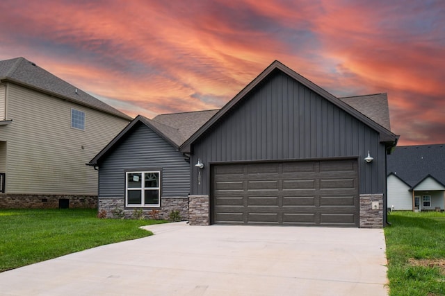 view of front facade with a yard and a garage