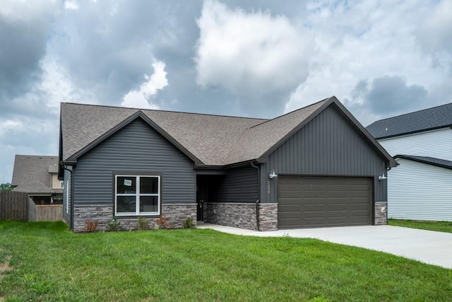 view of front of house with a front yard and a garage