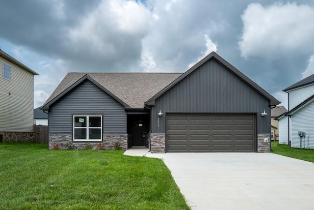 view of front of home featuring concrete driveway, stone siding, roof with shingles, an attached garage, and a front yard