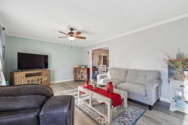 living room featuring ceiling fan, crown molding, and wood-type flooring