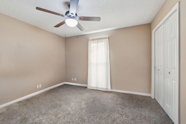 unfurnished bedroom featuring ceiling fan, carpet, a closet, and a textured ceiling